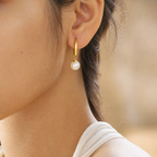 Noelle Pearl Drop Hoop Earrings in 18K gold-plated finish worn on the ear