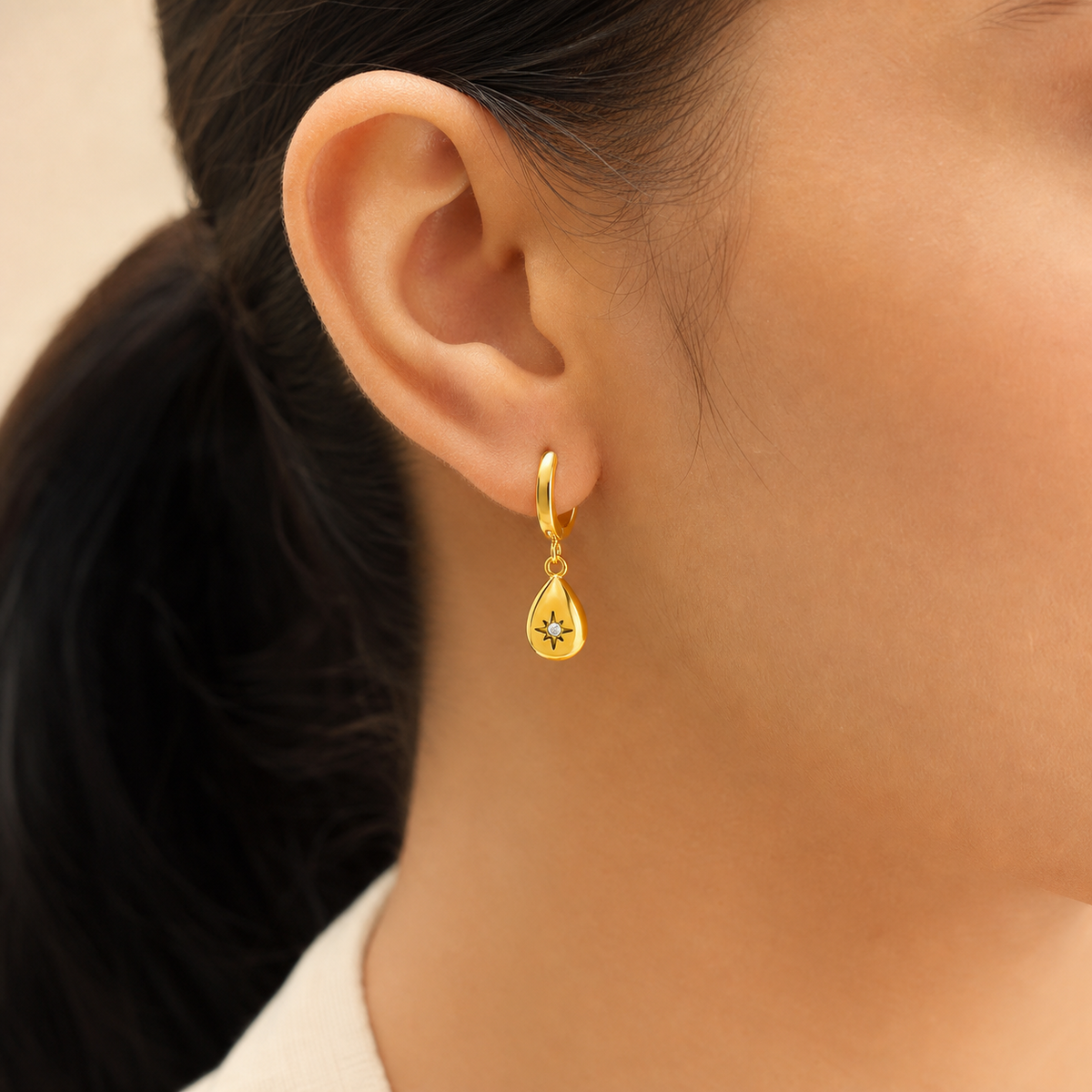 Sophia Teardrop Zircon Hoop Earrings in gold-tone finish worn on the ear