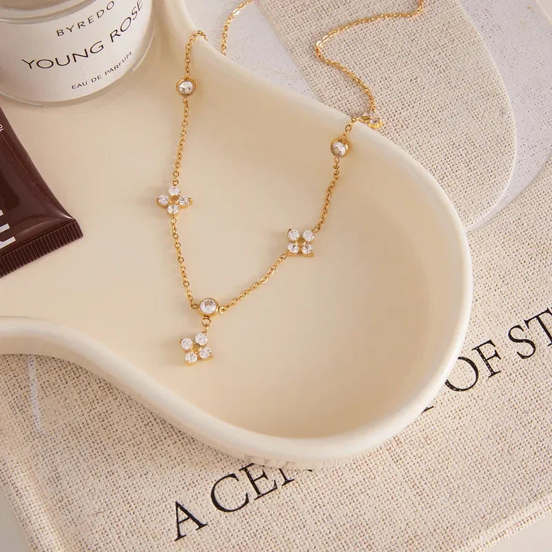Pretty Shimmering Things gold-tone stainless steel station necklace with floral cubic zirconia accents.
