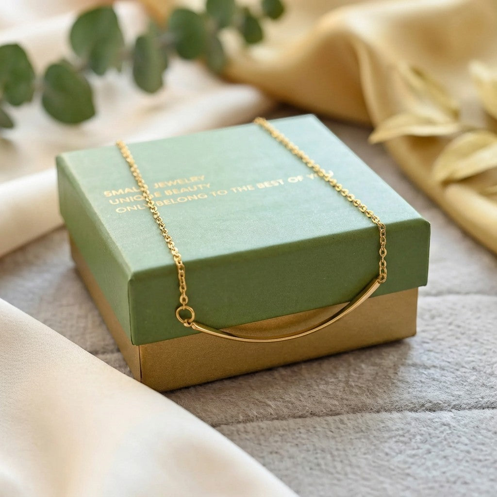 Pretty Shimmering Things Global Sunrise Curve Minimal Necklace featuring a gold curved bar pendant on a delicate chain.