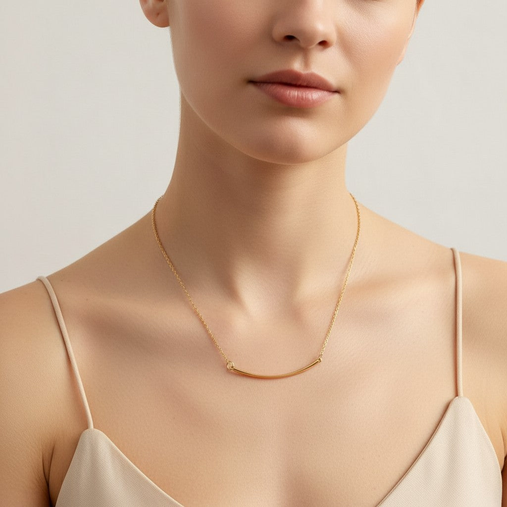 Pretty Shimmering Things Global Sunrise Curve Minimal Necklace featuring a gold curved bar pendant on a delicate chain.