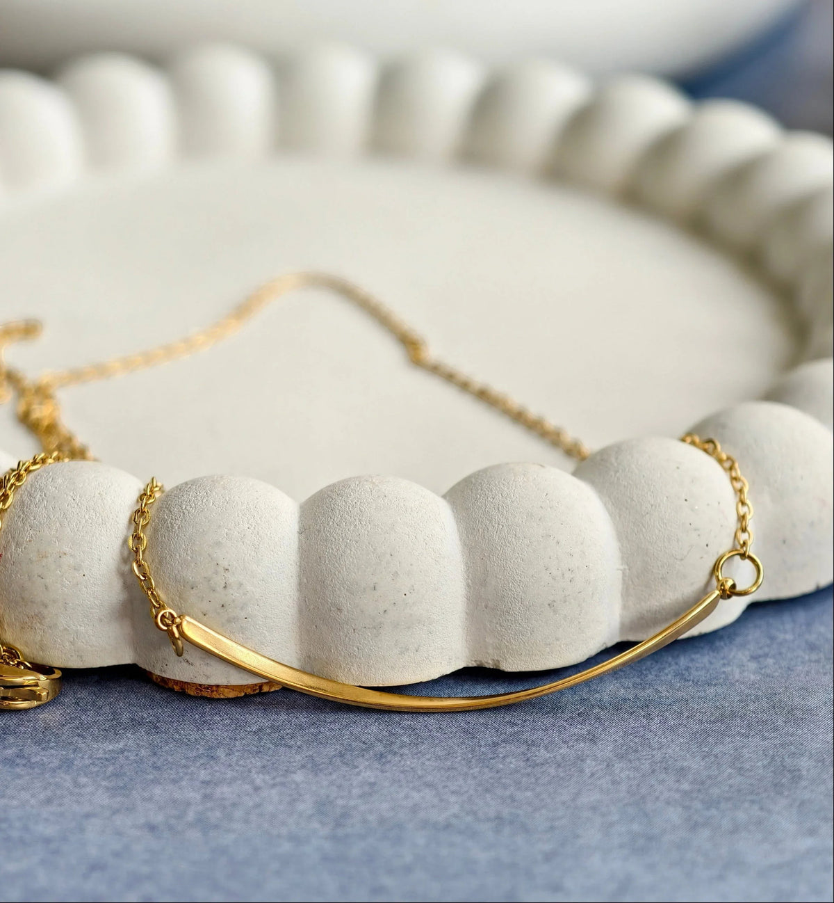 Sunrise Curve Minimal Necklace, close-up on a display