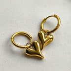 Lena Puff Heart Huggie Earrings, close-up on a display