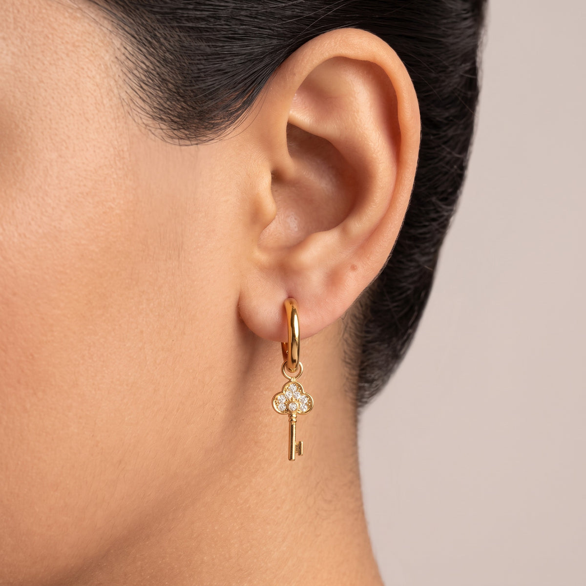 Meher Crystal Key Drop Earrings in 18K gold PVD-plated finish worn on the ear
