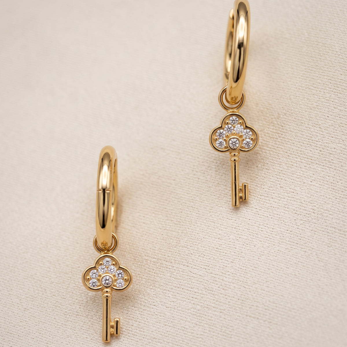 Meher Crystal Key Drop Earrings, styled flat lay