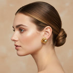 Nova Woven Knot Earrings in 18K gold PVD-plated finish worn on the ear