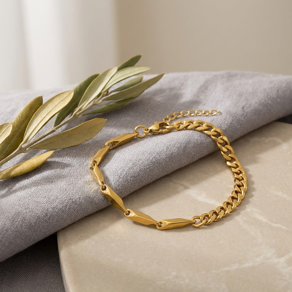 Pretty Shimmering Things Global gold-tone stainless steel bracelet featuring a mix of angular links and curb chain.