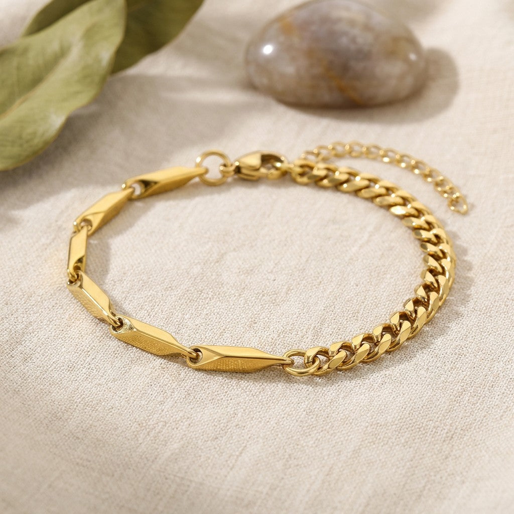 Pretty Shimmering Things Global gold-tone stainless steel bracelet featuring a mix of geometric and curb chain links.