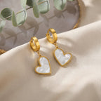Seraphine Pearl Heart Earrings, close-up on a display
