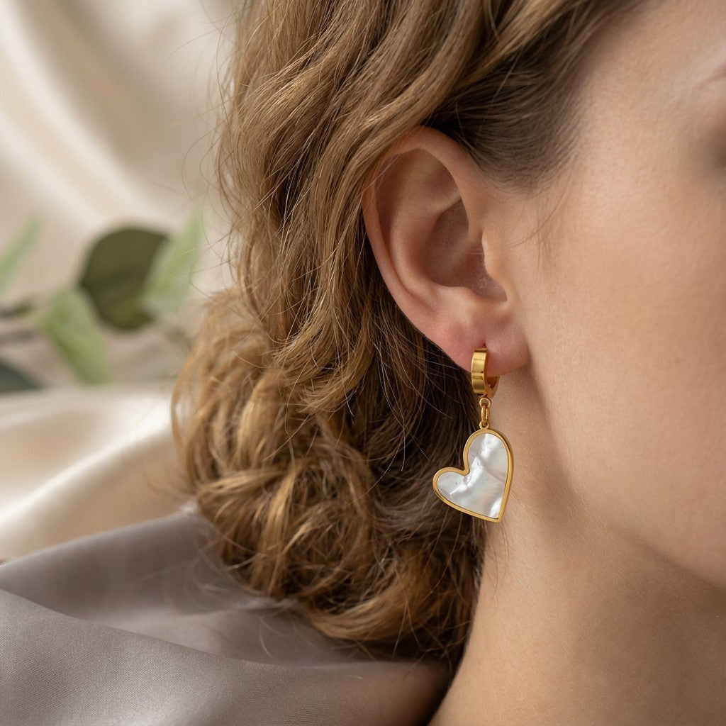 Seraphine Pearl Heart Earrings in 18K gold PVD-plated finish worn on the ear