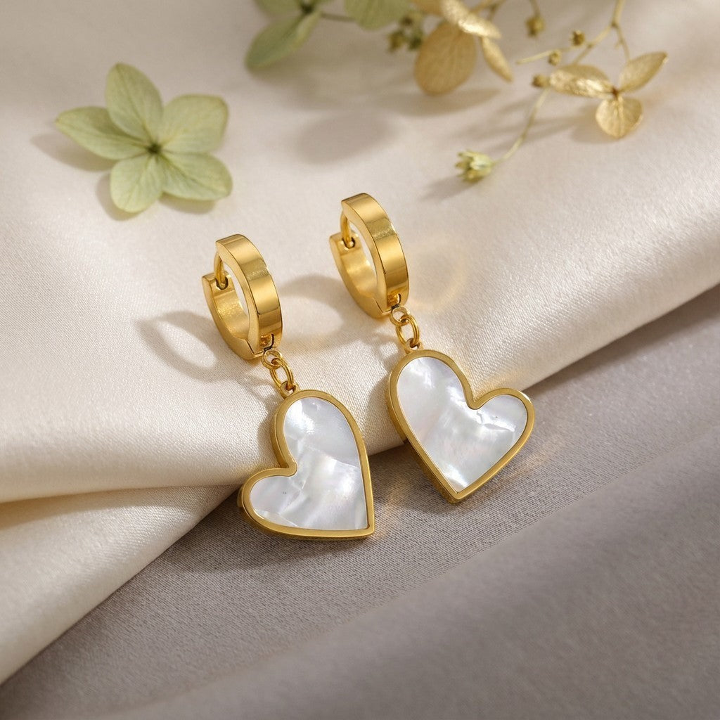 Seraphine Pearl Heart Earrings, styled flat lay