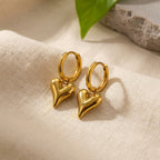 Lena Puff Heart Huggie Earrings, styled flat lay