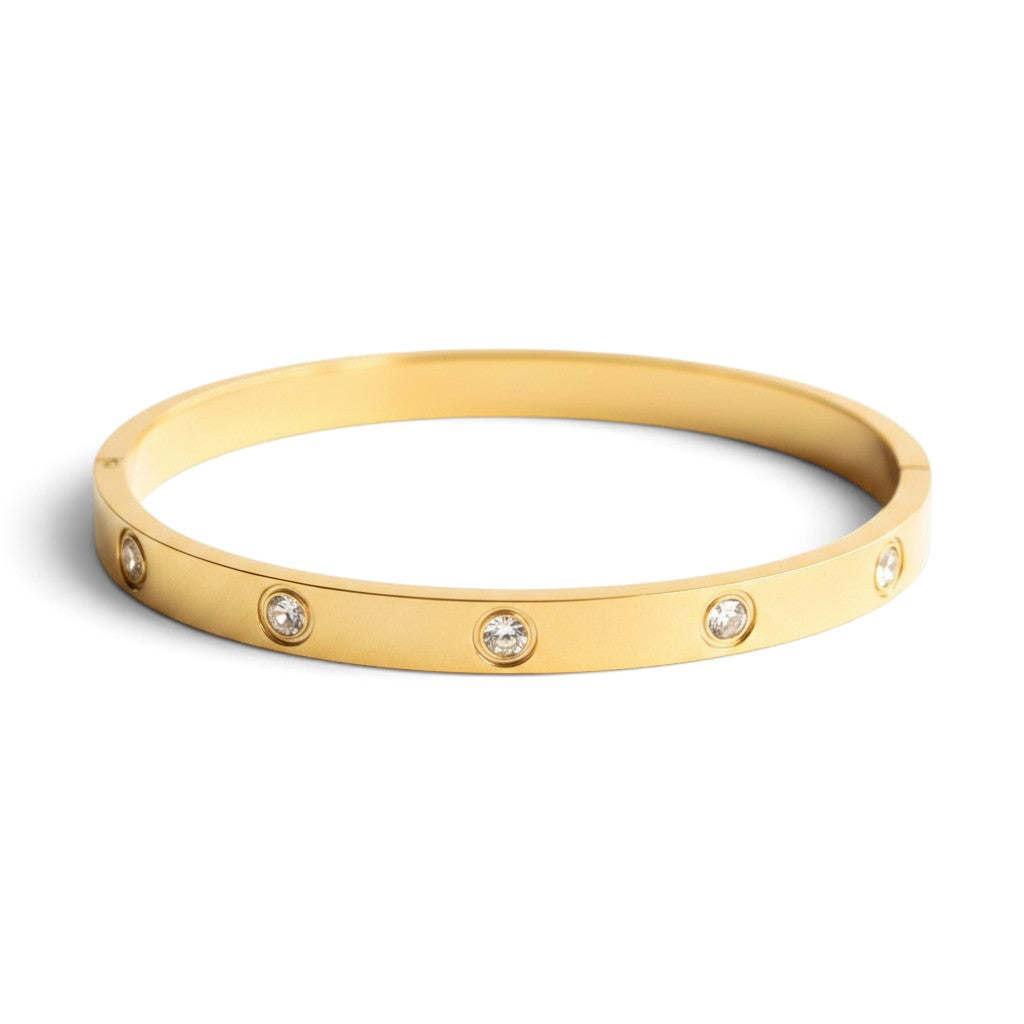 Pretty Shimmering Things Global 18K gold-plated stainless steel bangle with round rhinestone accents.