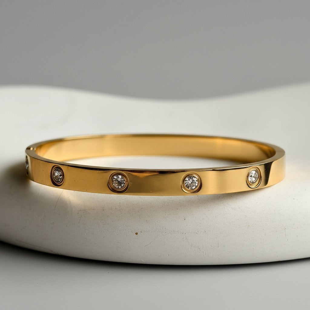 Pretty Shimmering Things Global Stella vintage 18K gold-plated stainless steel bangle with round rhinestone accents.