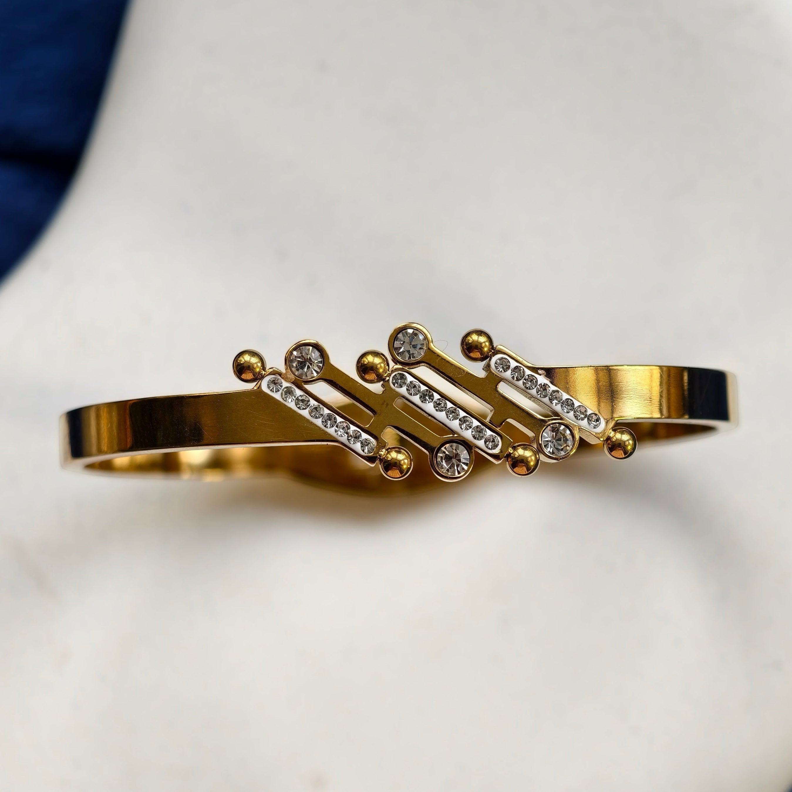 Pretty Shimmering Things Global Sola Bubble Luxe gold-tone stainless steel bangle with rhinestone-accented bars.