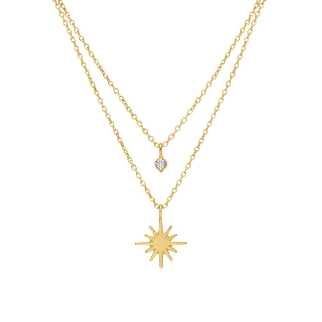 Pretty Shimmering Things Global gold layered necklace featuring a sparkling zircon charm and a radiant star pendant.