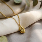 Stella Dewdrop Necklace, styled flat lay