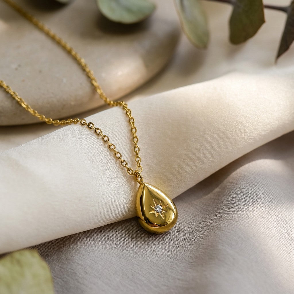 Stella Dewdrop Necklace, styled flat lay