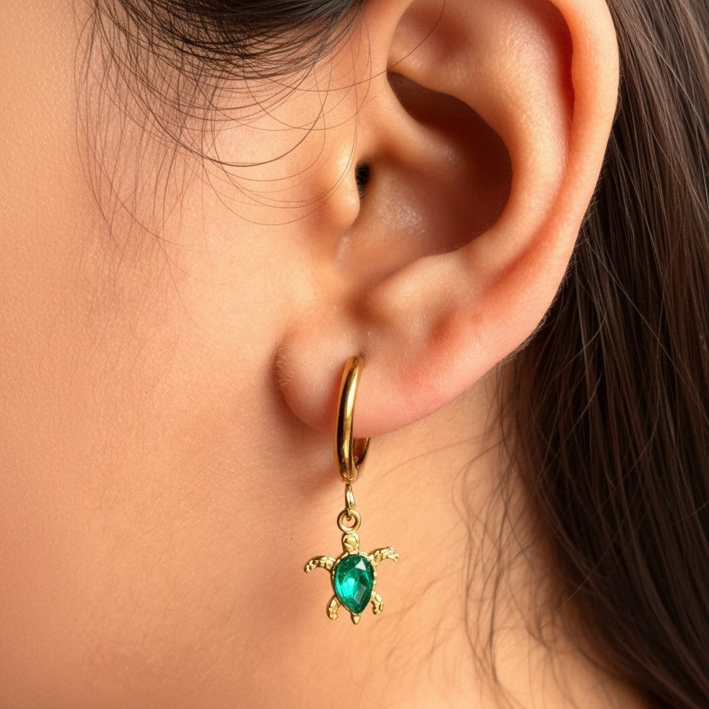 Marina Turtle Earrings in 18K gold PVD-plated finish worn on the ear