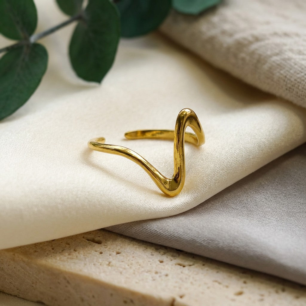 Pretty Shimmering Things Global Zara Wave adjustable ring in polished 18K gold-plated stainless steel on fabric