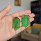 Isla Green Beaded Statement Earrings held in the hand to show scale