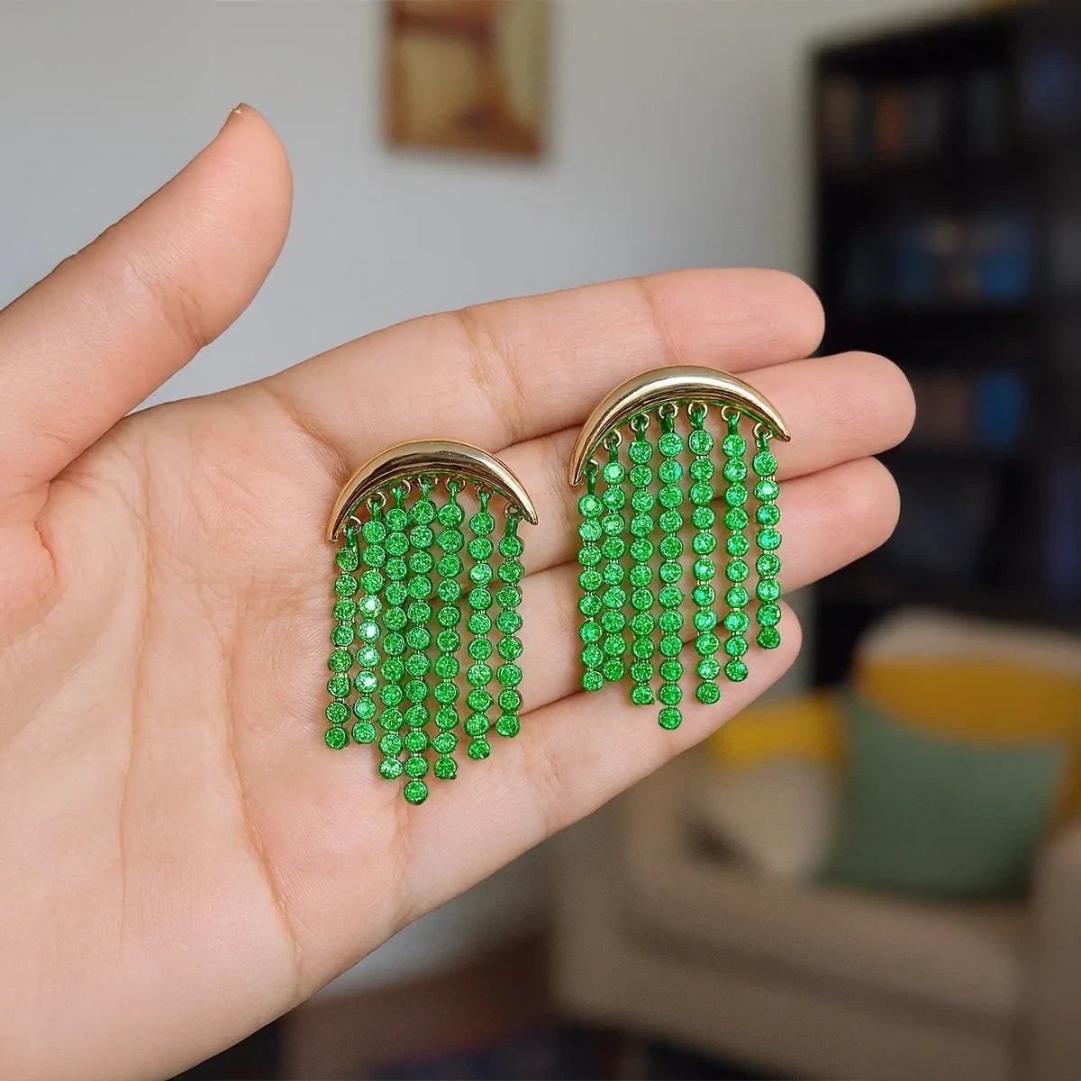 Isla Green Beaded Statement Earrings held in the hand to show scale