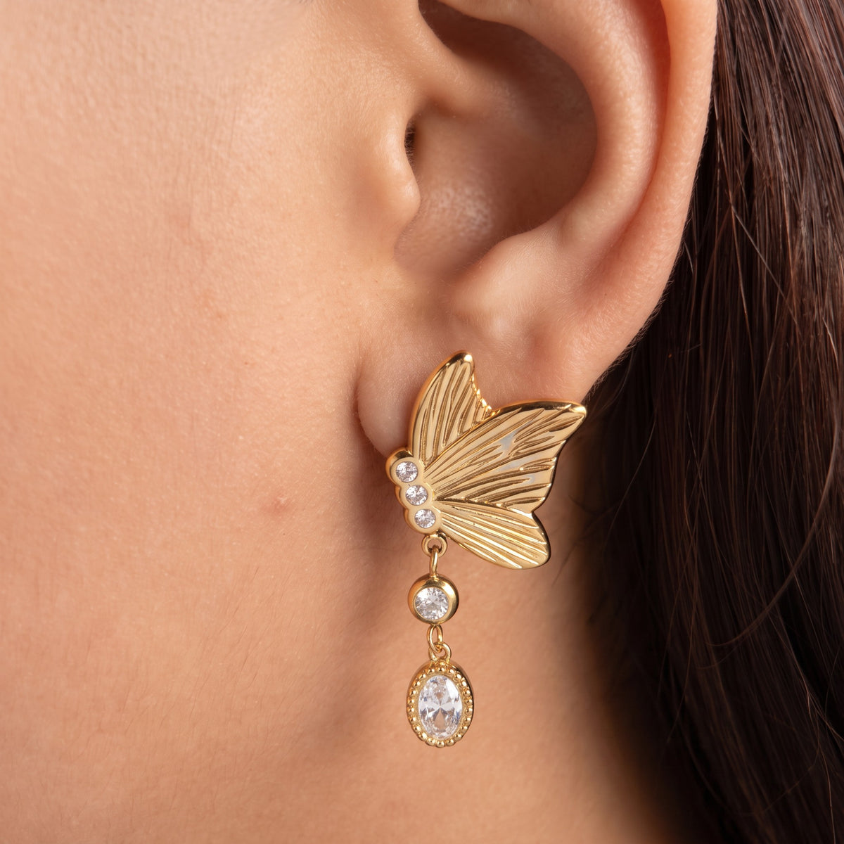 Noa Butterfly Earrings in 18K gold PVD-plated finish worn on the ear