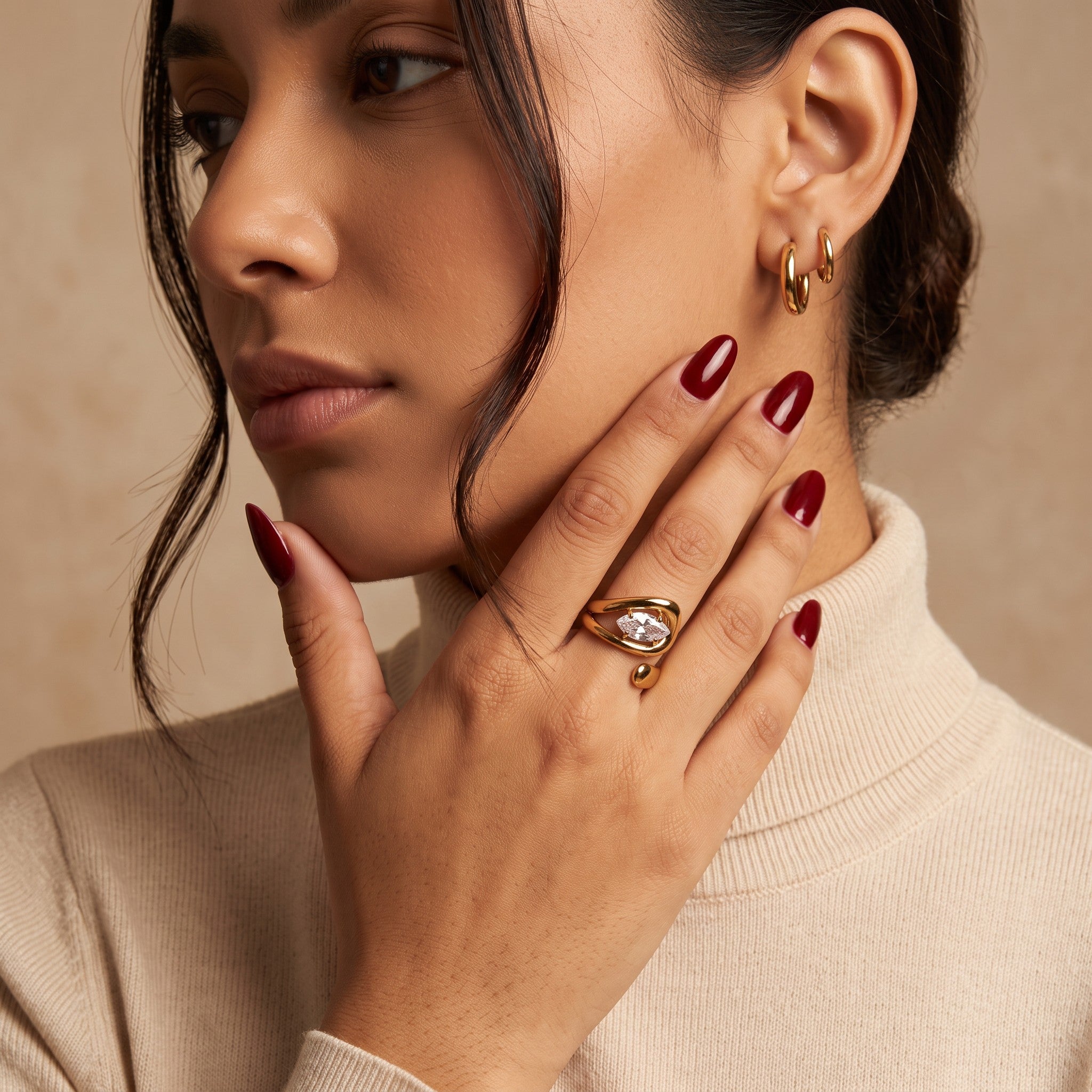 Pretty Shimmering Things Global Zaria sculptural open ring in gold stainless steel with a clear stone on a model