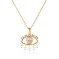 Pretty Shimmering Things gold-tone stainless steel evil eye necklace with a central crystal and dangling faux pearls.