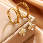 Pretty Shimmering Things gold hoop earrings with dangling flower charms featuring sparkling clear cubic zirconia stones.