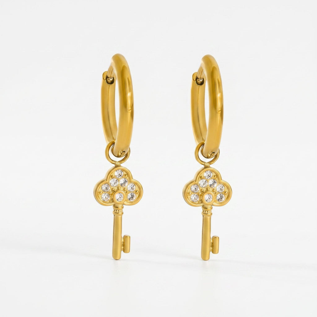 Pretty Shimmering Things gold-tone huggie hoop earrings with sparkling cubic zirconia key charms.