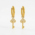 Pretty Shimmering Things gold-tone huggie hoop earrings with sparkling cubic zirconia key charms.