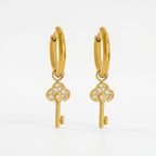 Pretty Shimmering Things gold-tone huggie hoop earrings with sparkling cubic zirconia key charms.