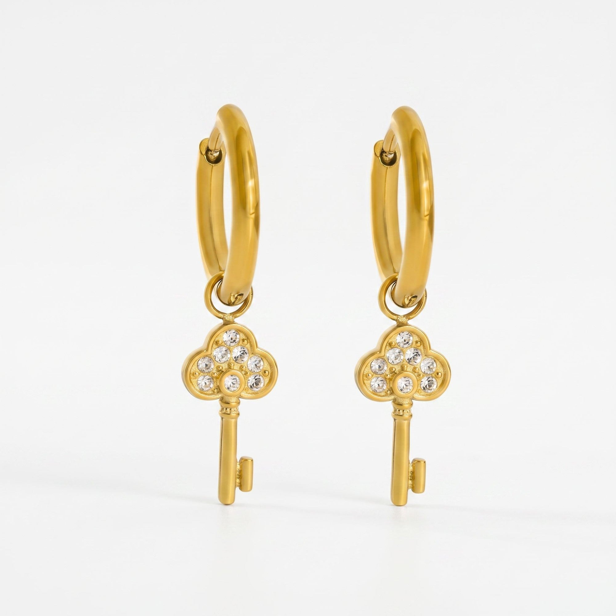 Pretty Shimmering Things gold-tone huggie hoop earrings with sparkling cubic zirconia key charms.