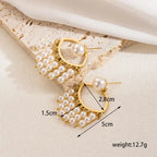 Pretty Shimmering Things gold-tone statement earrings with a cascading faux pearl fringe and open-frame design.